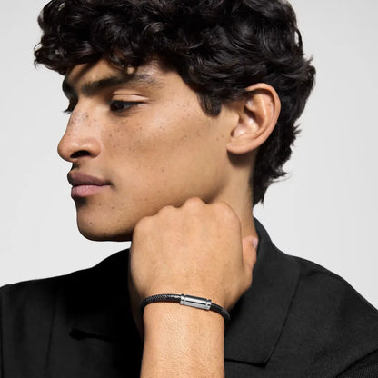 Man wearing a Velmont bracelet on a plain background